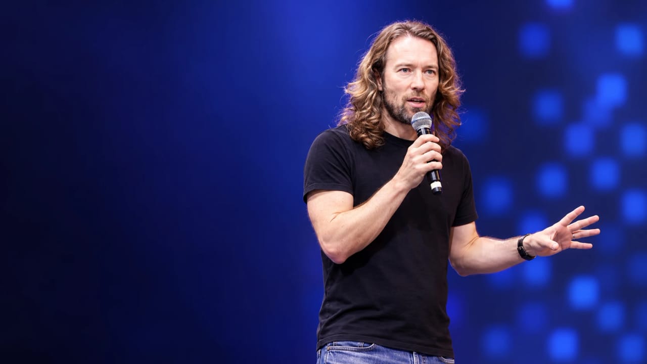An AI-assisted editorial portrait based on the GOSIM photograph of DHH speaking; original event photo appears below.